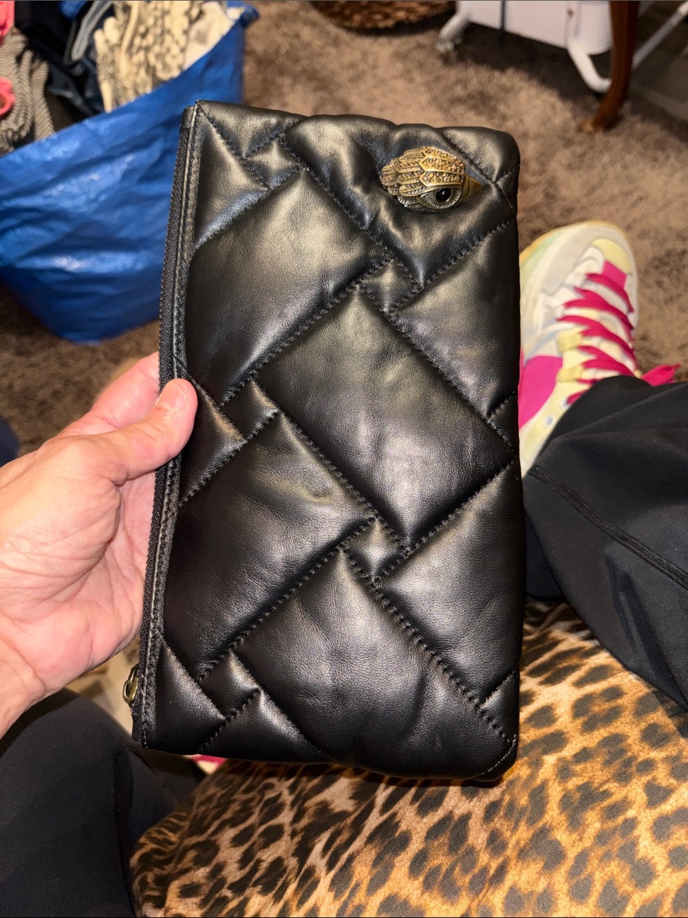KURT GEIGER London: Black Quilted Leather Zip Clutch with Decorative Eye Accent